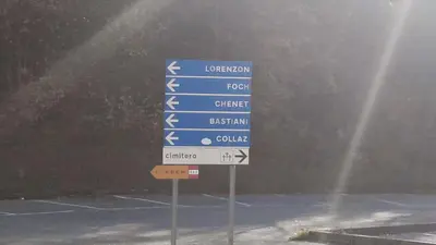 a blue street sign in a parking lot at Casa Alpina in Cencenighe