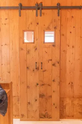 a wooden wall with two doors in a room at Casa del Lupo in Cortina dʼAmpezzo