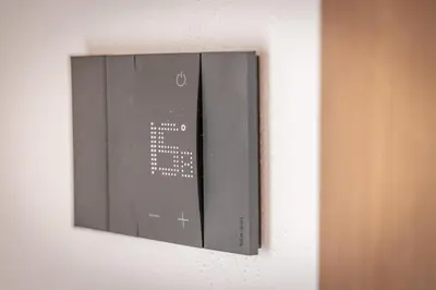 a control panel on the wall of a room at Casa del Lupo in Cortina dʼAmpezzo