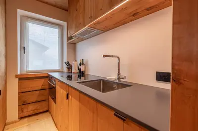 a kitchen with a stainless steel sink and a window at Casa del Lupo in Cortina dʼAmpezzo