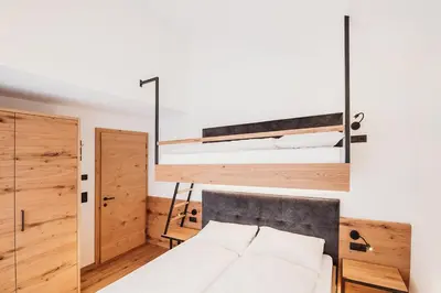 a bedroom with two bunk beds in a room at Höllerhof Brixen in Albes