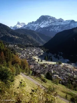 a town in a valley with snow capped mountains at Casa Minela in Falcade