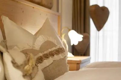 a close up of a pillow on a bed at Hotel Chalet Giasenei in Sagron Mis