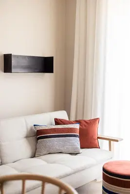 a living room with a white couch and a window at Mondschein Apartments in Lana