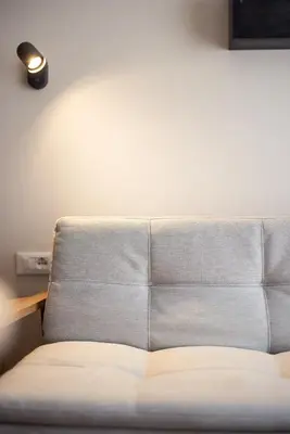 a bed in a room with a wall at Mondschein Apartments in Lana