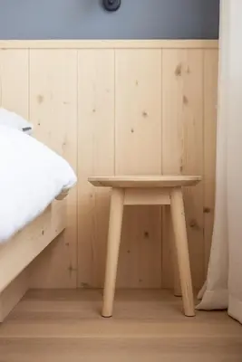 a small wooden table in a room with a bed at Mondschein Apartments in Lana