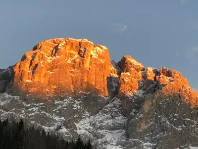 a rocky mountain with snow on top of it at Piccola Stella Alpina in Canale dʼAgordo