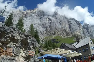 a view of a mountain with a building in front at Piccola Stella Alpina in Canale dʼAgordo