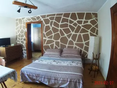 a bedroom with a large bed in a room at Piccola Stella Alpina in Canale dʼAgordo