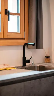 a kitchen counter with a sink and a window at Apartments, Guest House & historic Chalet Neuhaus in San Sigismondo