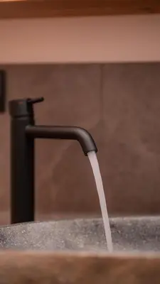 a stream of water coming out of a faucet at Apartments, Guest House & historic Chalet Neuhaus in San Sigismondo