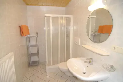 a white bathroom with a sink and a mirror at Puitnhof in Caldaro