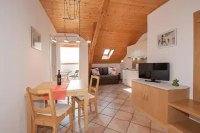 a kitchen and dining room with a table and chairs at Puitnhof in Caldaro