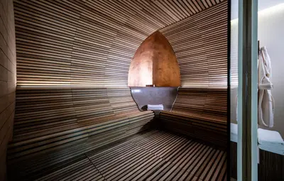 a room with a wooden bench in a room at Hotel Überbacher in Laion