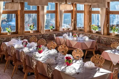 a set of tables in a room with windows at Hotel Überbacher in Laion