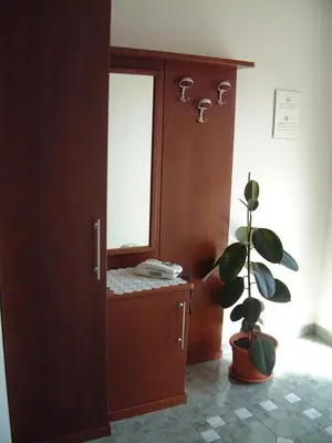 a room with a mirror and a phone on a cabinet at Residence Hofer in Valdaora