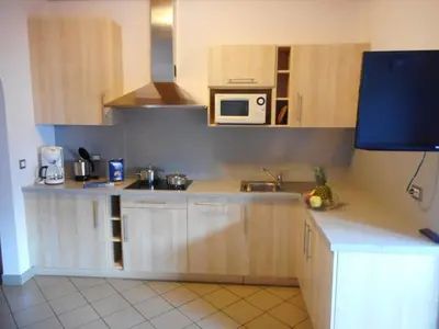 a kitchen with wooden cabinets and a microwave at Residence Hofer in Valdaora