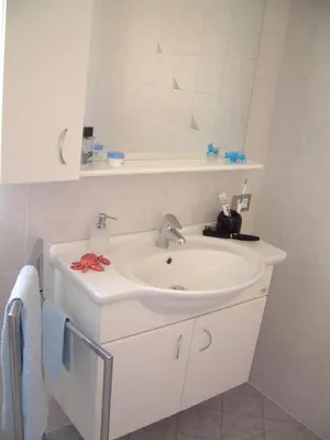 a bathroom with a white sink and a mirror at Residence Hofer in Valdaora