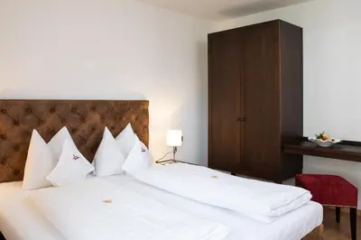 a group of white pillows on a bed at Residence Iris in Valdaora