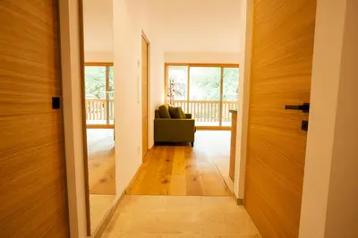 a hallway with a door leading to a living room at Lahnhof in Lana