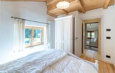 a bedroom with a white bed and a window at Beautiful Home In Castello Tesino in Castello Tesino