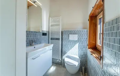 a bathroom with a sink and a toilet and a mirror at Beautiful Home In Castello Tesino in Castello Tesino