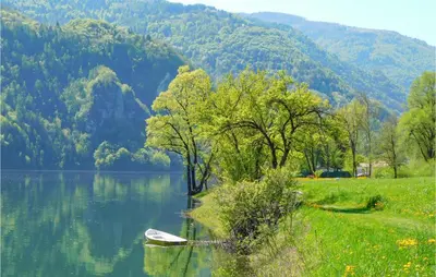 a boat sitting in the middle of a lake at Beautiful Home In Castello Tesino in Castello Tesino