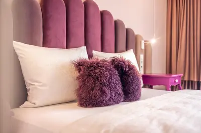 a bed with two stuffed teddy bears on it at Loom in Bolzano
