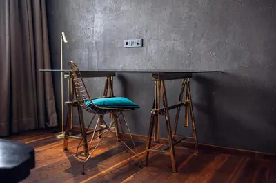 a table with two chairs and a table with a blue seat at Loom in Bolzano