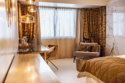 a bedroom with a bed and a table and a chair at Loom in Bolzano