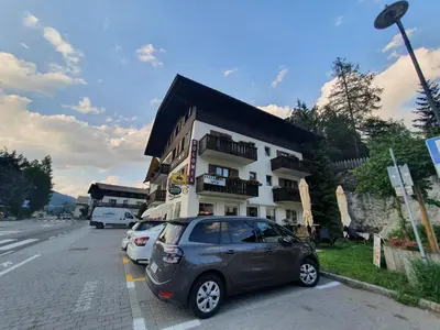 a small car parked in front of a building at ALBERGO BAR RISTORANTE DOLOMIA in Badia