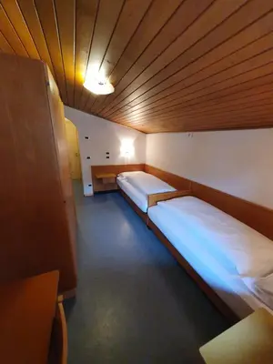 a small room with two beds in it at ALBERGO BAR RISTORANTE DOLOMIA in Badia