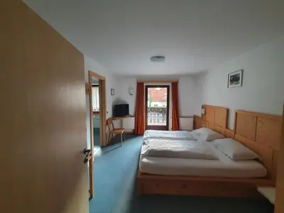 a bedroom with a large bed and a window at ALBERGO BAR RISTORANTE DOLOMIA in Badia