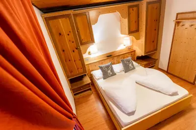 a bedroom with a bed in a room at Albergo Dolomiti in Cavalese