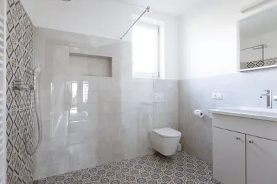 a bathroom with a shower and a toilet and a sink at Valentinhof - organic farm in Merano