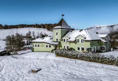 a house with snow on the ground in front at Villa Pana in Santa Cristina in Val Gardena