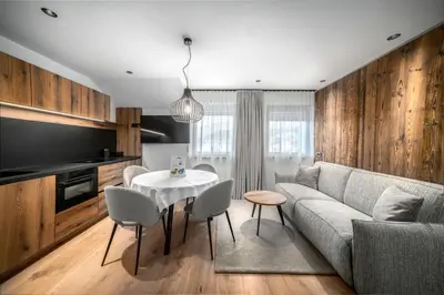 a living room with a couch and a table at Villa Pana in Santa Cristina in Val Gardena