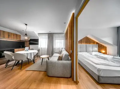 a bedroom with a bed and a table and chairs at Villa Pana in Santa Cristina in Val Gardena