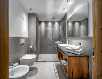 a bathroom with two sinks and a toilet and a tub at Villa Pana in Santa Cristina in Val Gardena