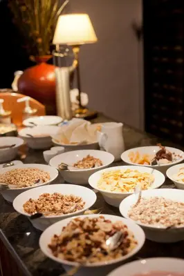 a table topped with white bowls filled with food at Hotel Restaurant Lilie in Vipiteno
