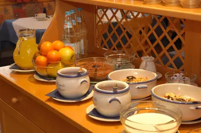 a table with bowls of food and other dishes on it at Residence Viktoria in Castelrotto
