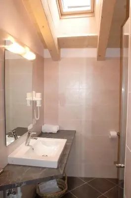 a bathroom with a sink and a mirror at Residence Viktoria in Castelrotto