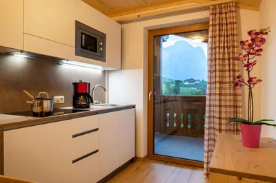 a kitchen with a counter top and a window at Residence Viktoria in Castelrotto