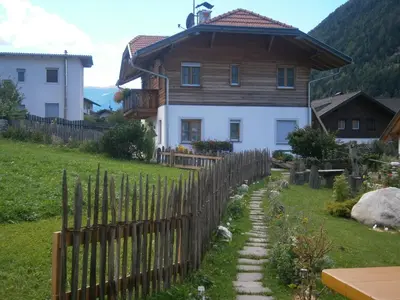 a wooden fence in front of a house at Ortnerhof in Gais