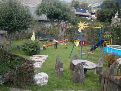 a garden with a playground with a play equipment at Ortnerhof in Gais