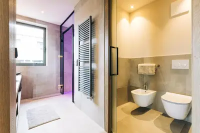 a bathroom with a toilet and a shower at La Rosea - Fine Living Apartments in Appiano sulla Strada del Vino