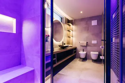 a purple bathroom with two toilets and a sink at La Rosea - Fine Living Apartments in Appiano sulla Strada del Vino