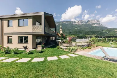 a house with a view of the mountain at La Rosea - Fine Living Apartments in Appiano sulla Strada del Vino