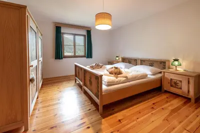 a bedroom with a bed with a dog laying on it at Villa Vintila with Whirlpool & Sauna in Vandoies