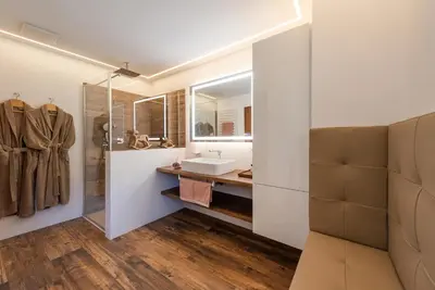 a bathroom with a sink and a mirror at Villa Vintila with Whirlpool & Sauna in Vandoies